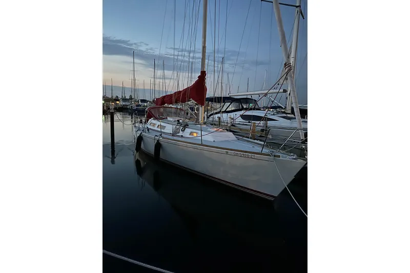 Slide: The Image of 1992 J Boats J/35 sailboat docked at marina during sunset. - 7