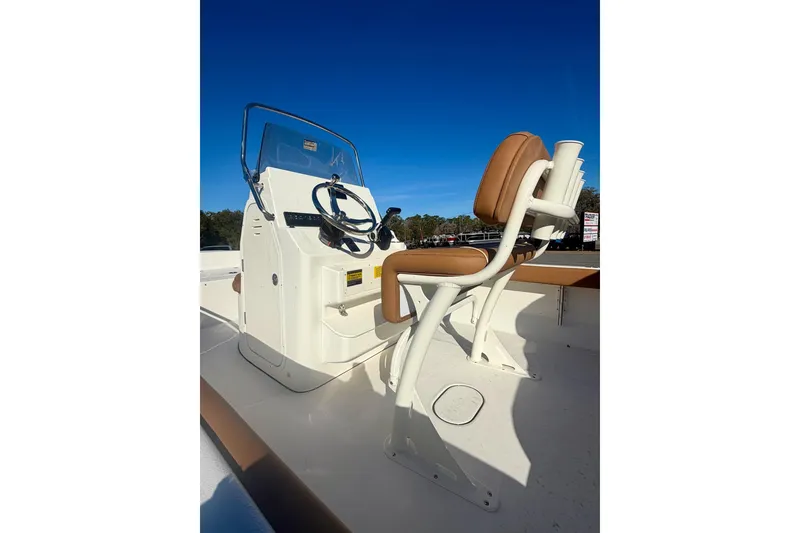 Slide: The Image of 2026 Key West 189 FS boat console and seating under clear blue sky. - 12