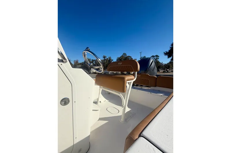 Slide: The Image of 2026 Key West 189 FS boat interior with steering wheel and seating under clear blue sky. - 14