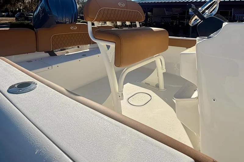 Slide: The Image of 2026 Key West 189 FS boat interior with tan seating and steering console. - 8