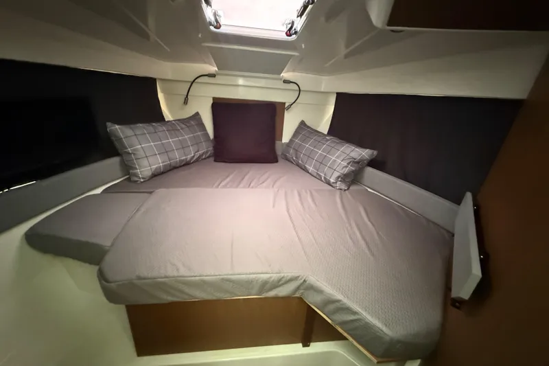 Slide: The Image of Cozy cabin interior of 2019 Beneteau Antares 27 with plush bedding and pillows. - 10