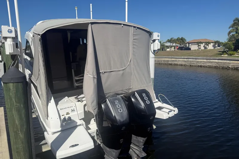 Slide: The Image of 2019 Beneteau Antares 27 docked with twin outboard engines, covered cockpit. - 13