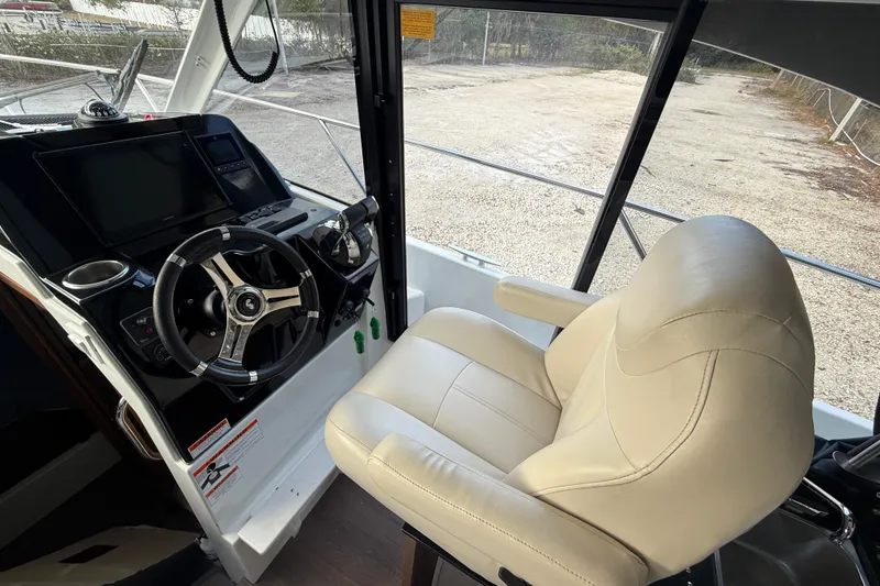 Slide: The Image of Helm of 2019 Beneteau Antares 27 with steering wheel and captain's chair. - 8