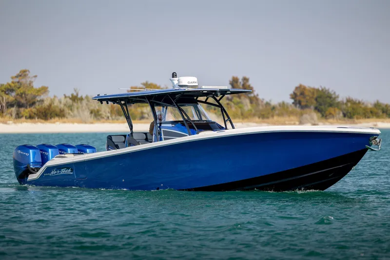 The Image of 2020 Nor-Tech 390 Sport Center Console boat cruising on water, featuring a sleek blue design. - 0