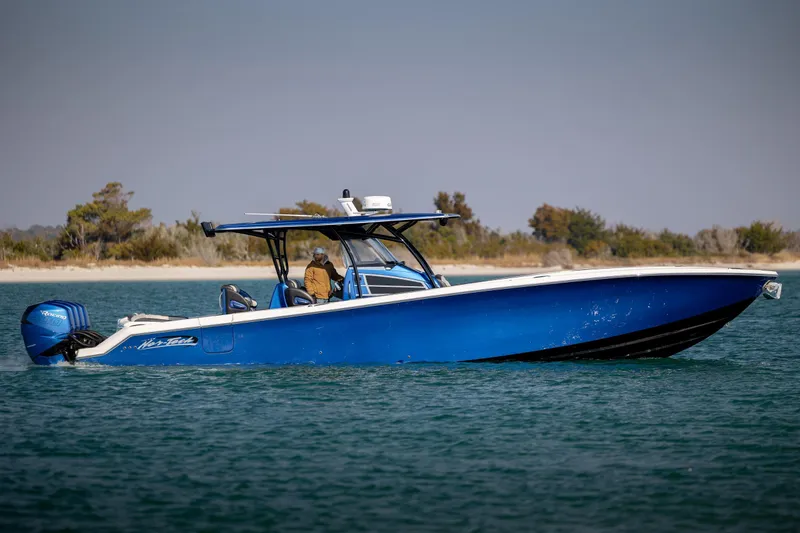 Slide: The Image of 2020 Nor-Tech 390 Sport Center Console boat cruising on calm waters. - 12