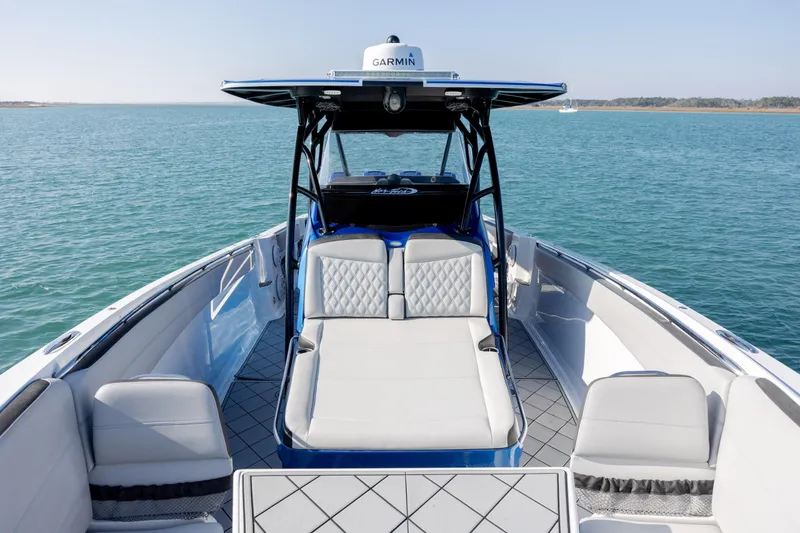Slide: The Image of 2020 Nor-Tech 390 Sport Center Console on calm blue water, featuring luxurious seating. - 17