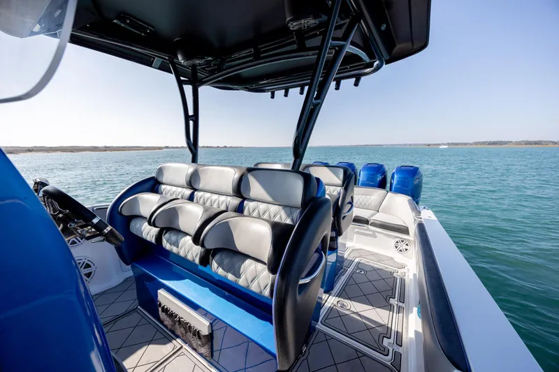 Slide: The Image of 2020 Nor-Tech 390 Sport Center Console boat interior with seating and ocean view. - 24