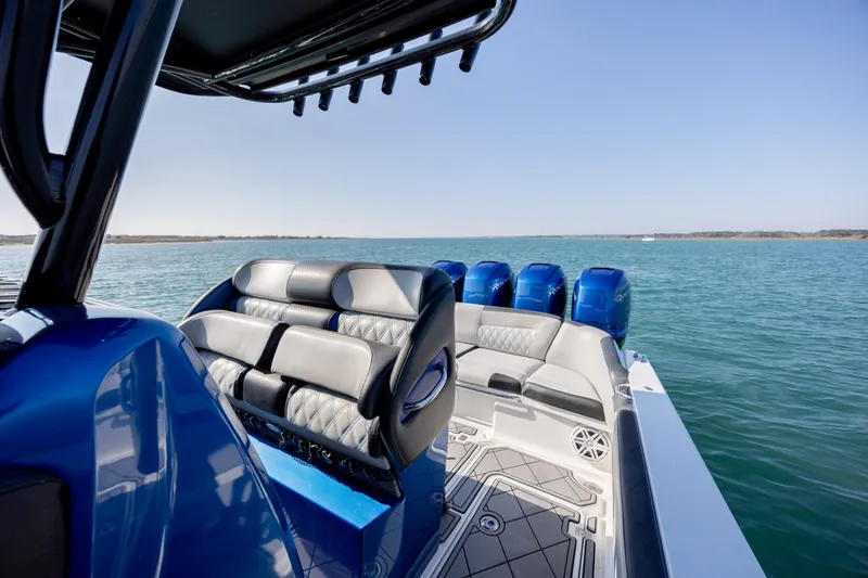 Slide: The Image of 2020 Nor-Tech 390 Sport Center Console boat on open water, featuring luxurious seating. - 25