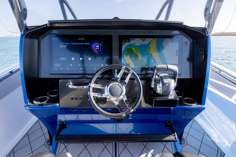 Slide: The Image of 2020 Nor-Tech 390 Sport Center Console dashboard with navigation and audio controls. - 27