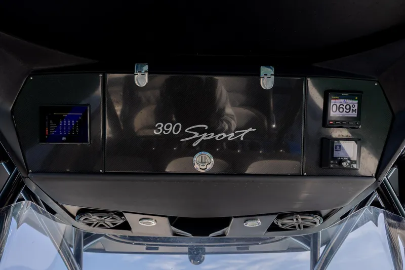 Slide: The Image of 2020 Nor-Tech 390 Sport Center Console dashboard with digital displays and controls. - 28