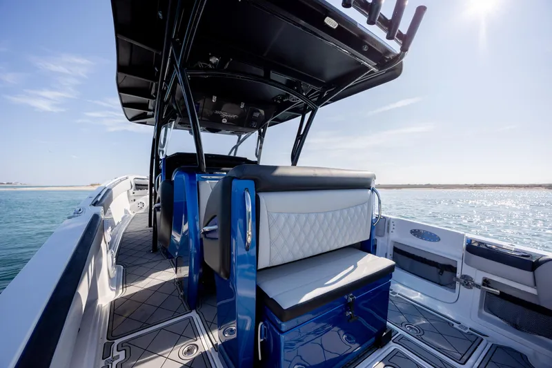 Slide: The Image of 2020 Nor-Tech 390 Sport Center Console boat interior with blue accents on open water. - 32