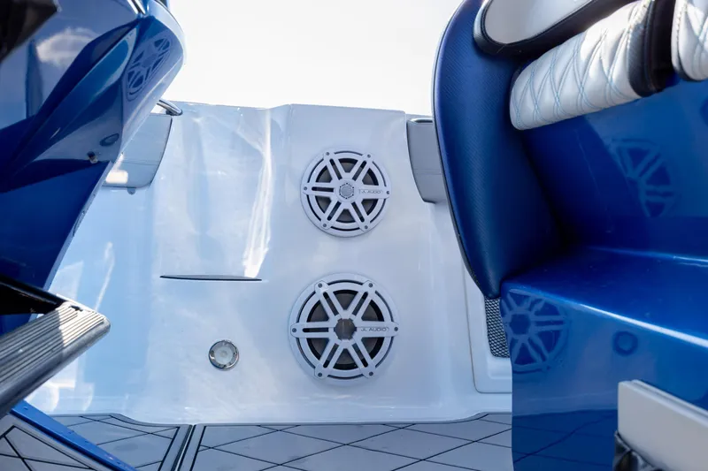 Slide: The Image of 2020 Nor-Tech 390 Sport Center Console interior with blue seating and audio speakers. - 34