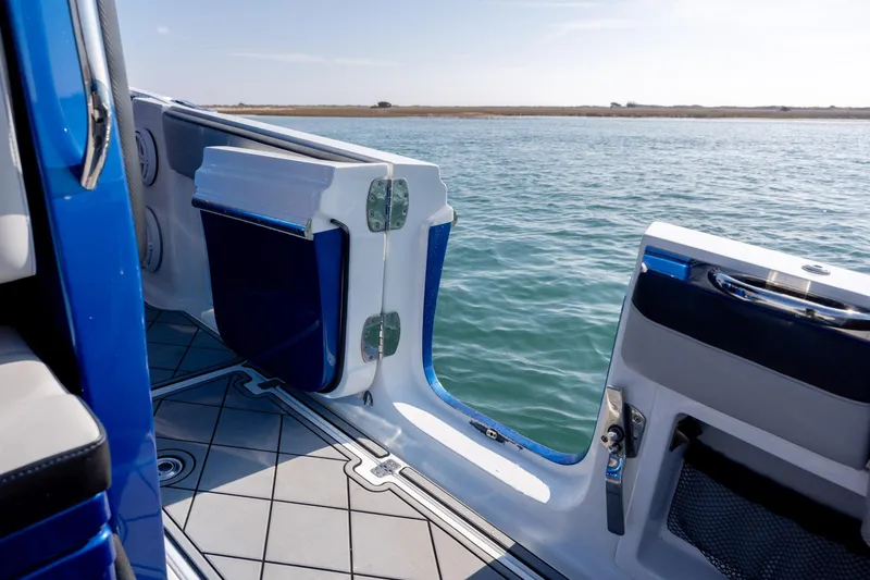Slide: The Image of 2020 Nor-Tech 390 Sport Center Console boat with open side door on calm water. - 35