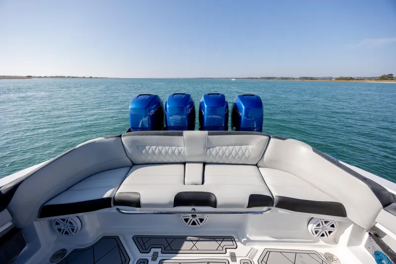 Slide: The Image of 2020 Nor-Tech 390 Sport Center Console boat with four blue engines on open water. - 36