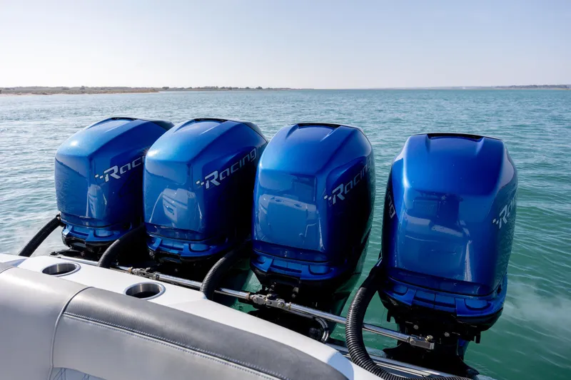 Slide: The Image of Four blue racing outboard motors on a 2020 Nor-Tech 390 Sport Center Console boat. - 37