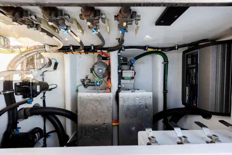 Slide: The Image of Engine compartment of 2020 Nor-Tech 390 Sport Center Console with visible wiring and components. - 38