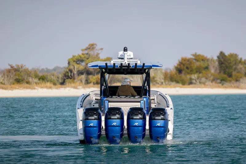 Slide: The Image of 2020 Nor-Tech 390 Sport Center Console boat with four powerful engines on water. - 5