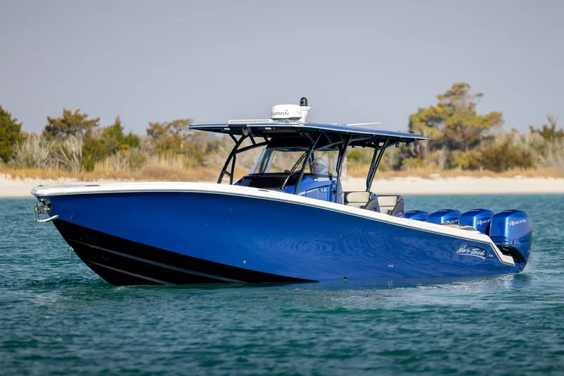 Slide: The Image of 2020 Nor-Tech 390 Sport Center Console boat on water, featuring sleek blue design. - 8