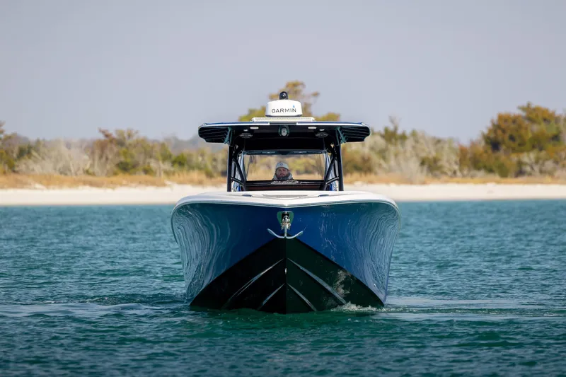 Slide: The Image of 2020 Nor-Tech 390 Sport Center Console boat cruising on calm water. - 9