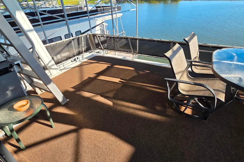 Slide: The Image of Upper deck of 1999 Stardust Cruisers 16x60 houseboat with chairs and table, overlooking water. - 13