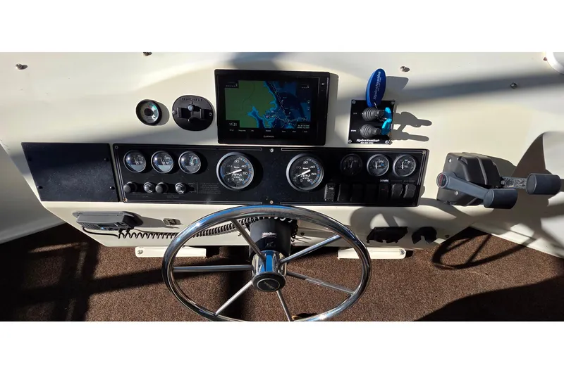 Slide: The Image of 1999 Stardust Cruisers 16x60 helm with navigation controls and gauges. - 15