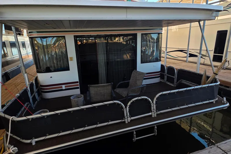 Slide: The Image of 1999 Stardust Cruisers 16x60 houseboat with a cozy deck and seating area. - 26