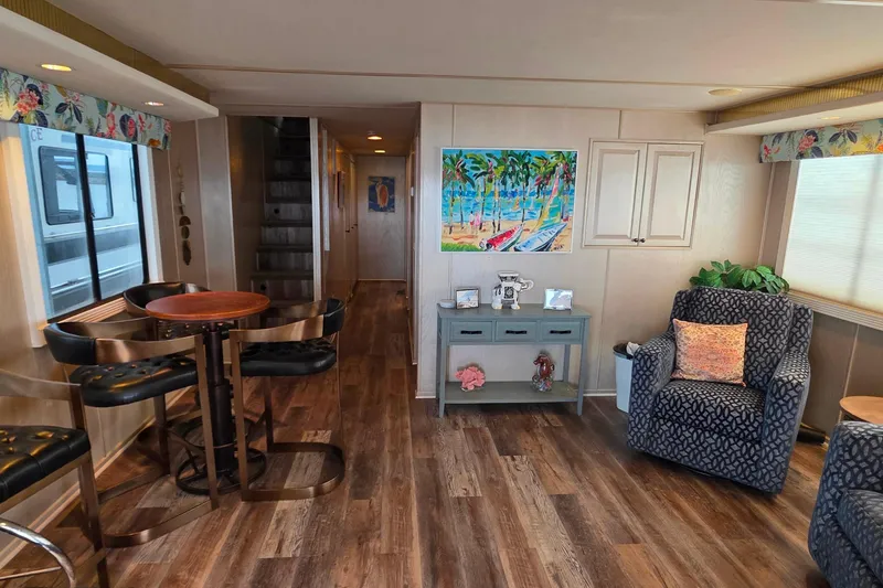 Slide: The Image of Interior of 1999 Stardust Cruisers 16x60 houseboat with cozy seating and vibrant decor. - 30