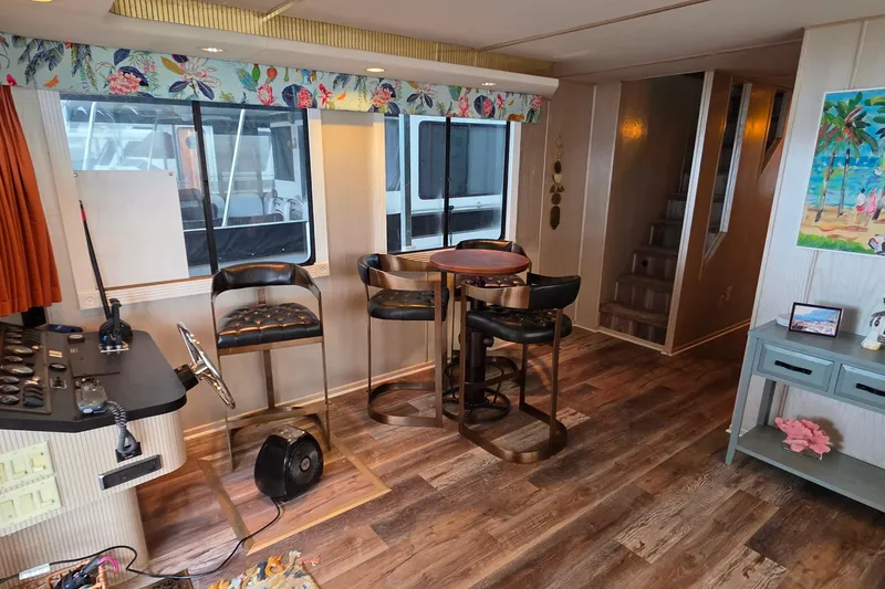 Slide: The Image of Interior of a 1999 Stardust Cruisers 16x60 houseboat with stylish decor and seating. - 31