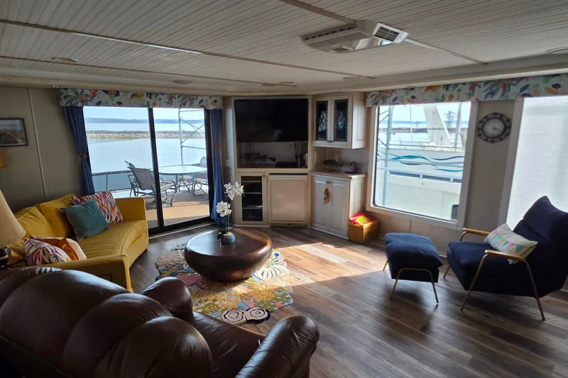 Slide: The Image of Interior of a 1999 Stardust Cruisers 16x60 houseboat with cozy seating and lake view. - 36