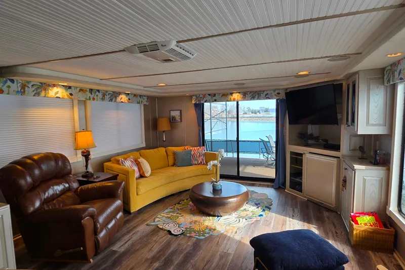 Slide: The Image of Luxurious 1999 Stardust Cruisers 16x60 houseboat interior with cozy seating and lake view. - 38