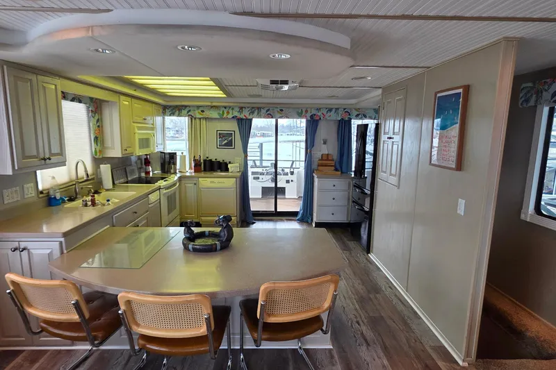 Slide: The Image of Interior of a 1999 Stardust Cruisers 16x60 houseboat with modern kitchen and dining area. - 39