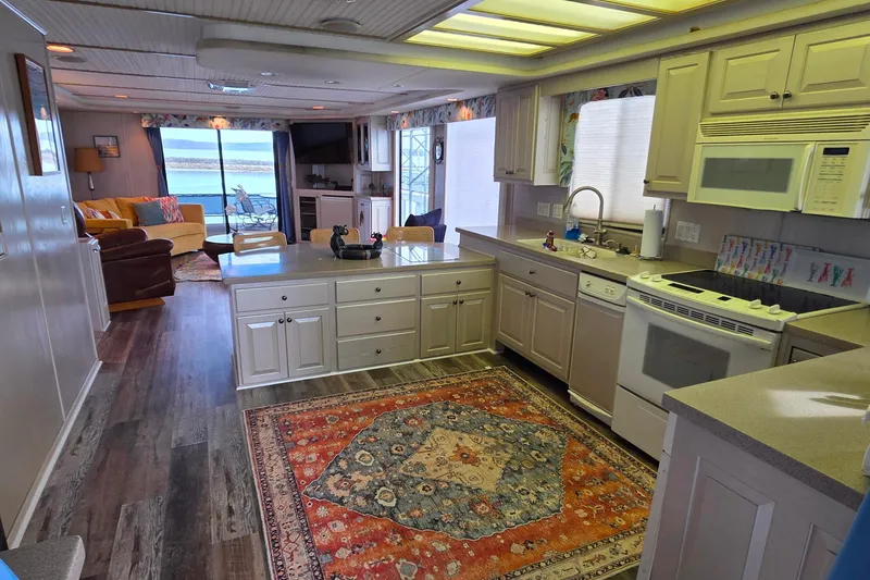 Slide: The Image of Interior of 1999 Stardust Cruisers 16x60 houseboat with kitchen and living area. - 41