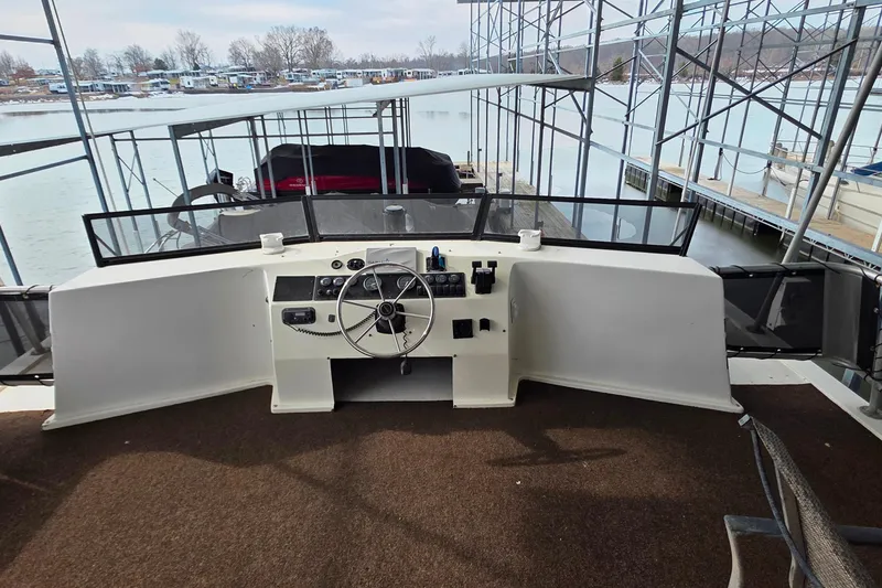 Slide: The Image of 1999 Stardust Cruisers 16x60 houseboat helm with steering wheel and control panel. - 45