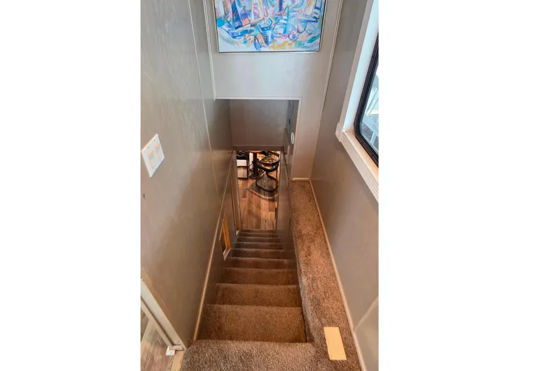 Slide: The Image of Staircase inside 1999 Stardust Cruisers 16x60 houseboat with colorful wall art. - 47