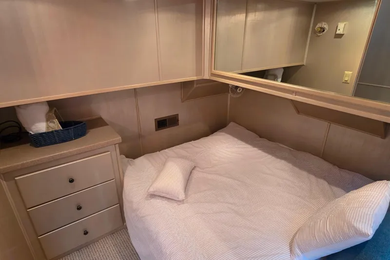 Slide: The Image of Cozy bedroom in 1999 Stardust Cruisers 16x60 houseboat with built-in storage and soft bedding. - 51
