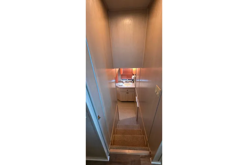 Slide: The Image of Interior view of 1999 Stardust Cruisers 16x60 houseboat, featuring stairs leading to a bathroom. - 53