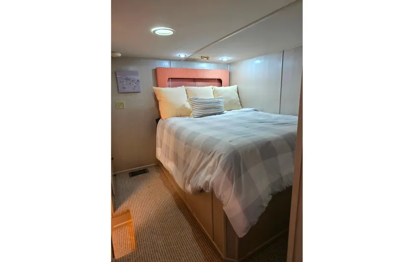 Slide: The Image of Cozy bedroom in 1999 Stardust Cruisers 16x60 houseboat with soft lighting and comfortable bedding. - 56