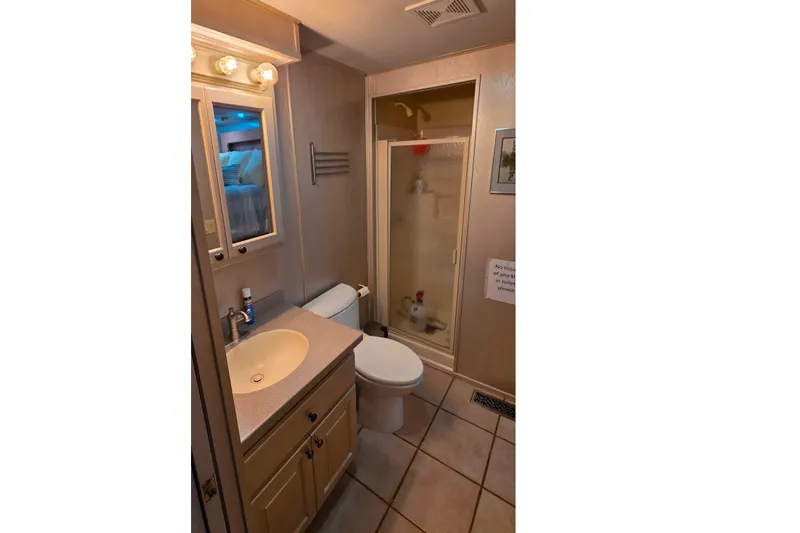Slide: The Image of Bathroom interior of 1999 Stardust Cruisers 16x60 houseboat with shower and vanity. - 57