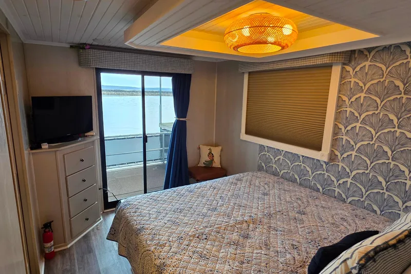 Slide: The Image of Cozy bedroom in 1999 Stardust Cruisers 16x60 houseboat with lake view. - 61