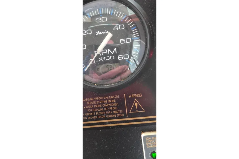 Slide: The Image of RPM gauge of 1999 Stardust Cruisers 16x60, showing 528 hours with warning label. - 68