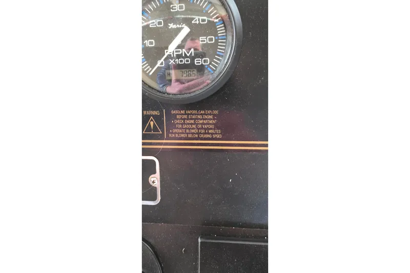 Slide: The Image of Close-up of a 1999 Stardust Cruisers 16x60 RPM gauge with warning label. - 69