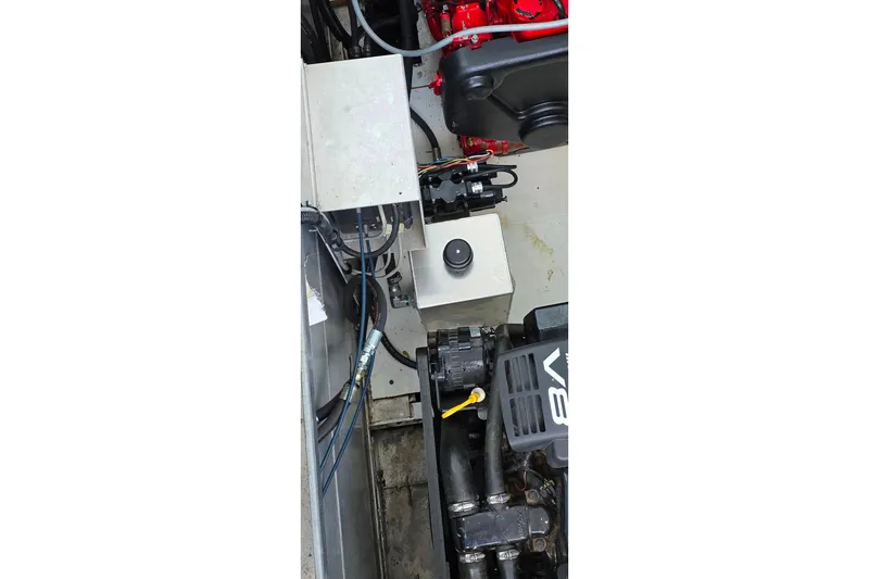 Slide: The Image of Engine compartment of a 1999 Stardust Cruisers 16x60 houseboat, featuring V8 engine components. - 72