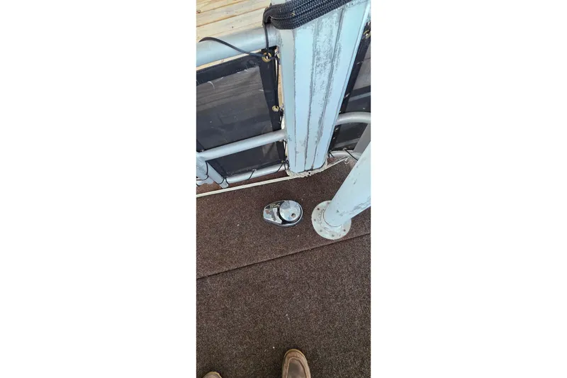 Slide: The Image of Deck area of a 1999 Stardust Cruisers 16x60 houseboat with metal railing and carpet flooring. - 77