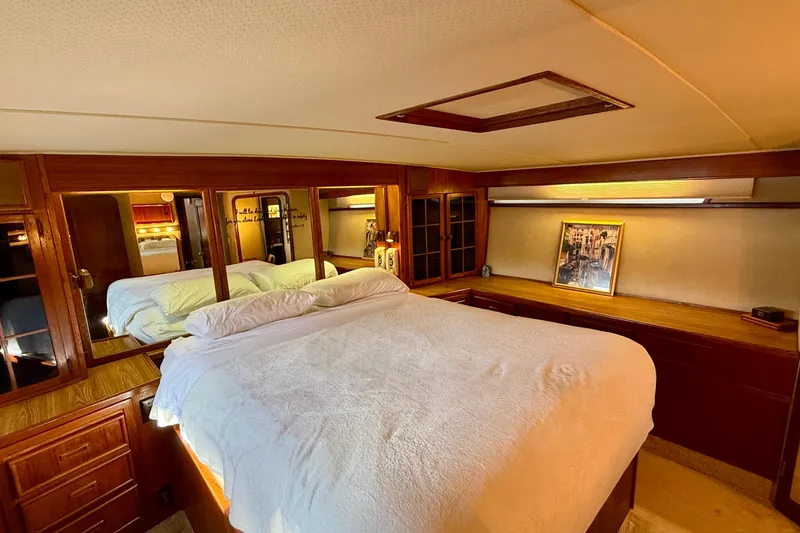 Slide: The Image of Luxurious bedroom interior of 1987 Chris-Craft 500 Constellation yacht with wood accents. - 11