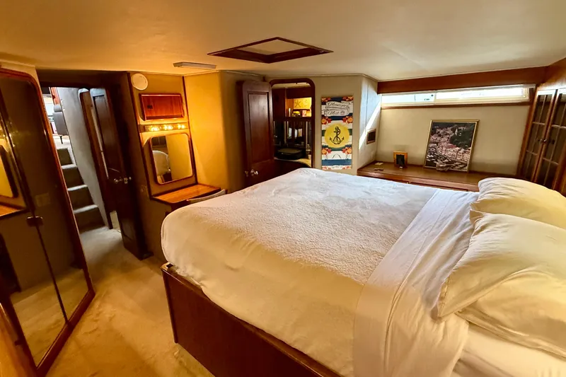 Slide: The Image of Luxurious bedroom interior of 1987 Chris-Craft 500 Constellation yacht with cozy bed and wooden accents. - 12