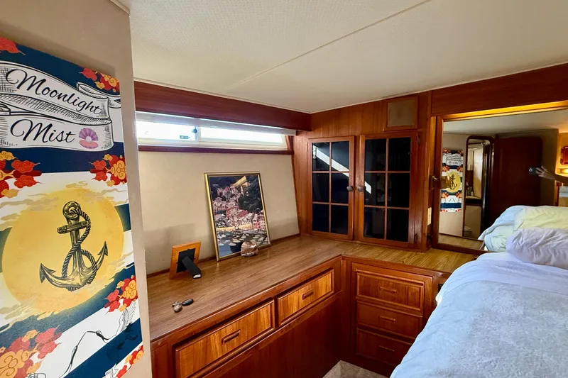 Slide: The Image of 1987 Chris-Craft 500 Constellation interior with wood cabinetry and nautical decor. - 13