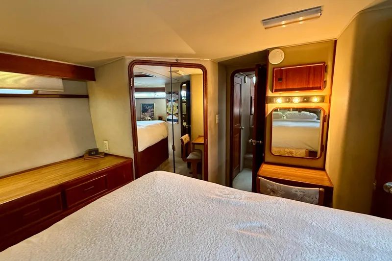 Slide: The Image of Interior of 1987 Chris-Craft 500 Constellation yacht bedroom with wood accents and vanity. - 14