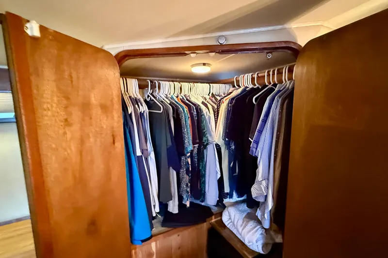 Slide: The Image of Closet inside 1987 Chris-Craft 500 Constellation yacht, filled with hanging clothes. - 15