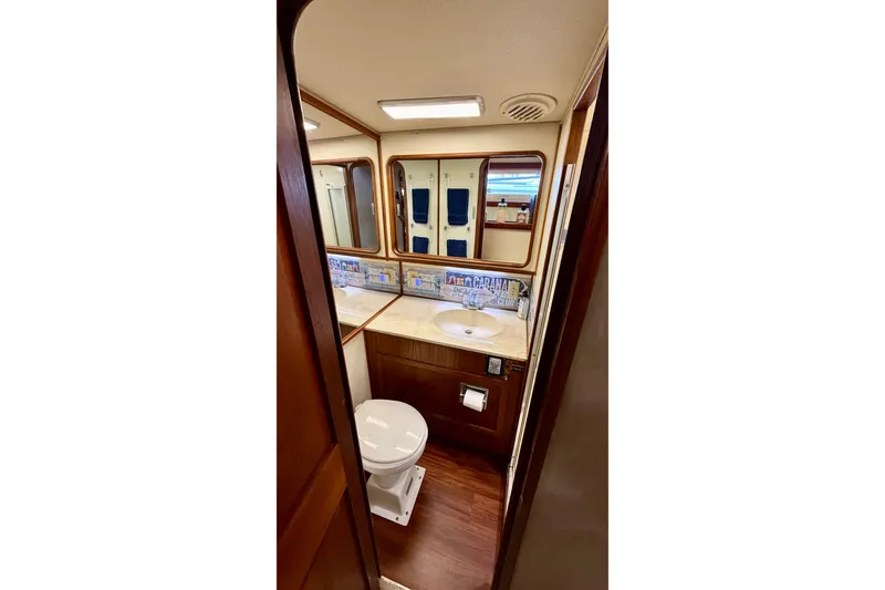 Slide: The Image of 1987 Chris-Craft 500 Constellation yacht bathroom with wood accents and modern fixtures. - 17