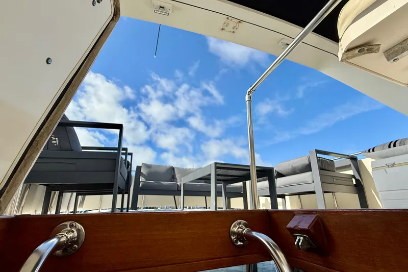 Slide: The Image of 1987 Chris-Craft 500 Constellation yacht deck with outdoor seating under blue sky. - 20